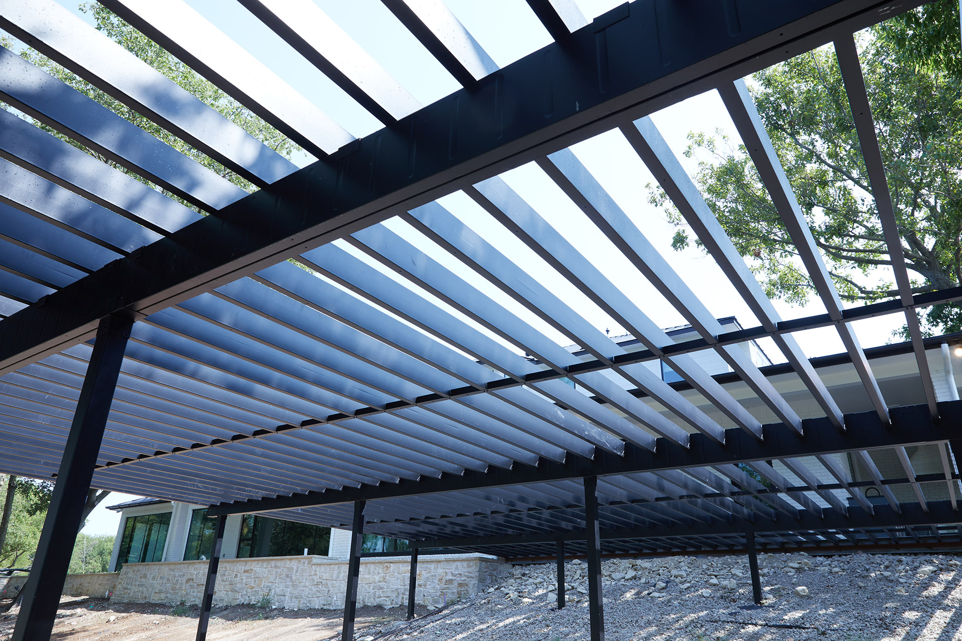 Underneath view of steel deck framing, showing strong straight lines.