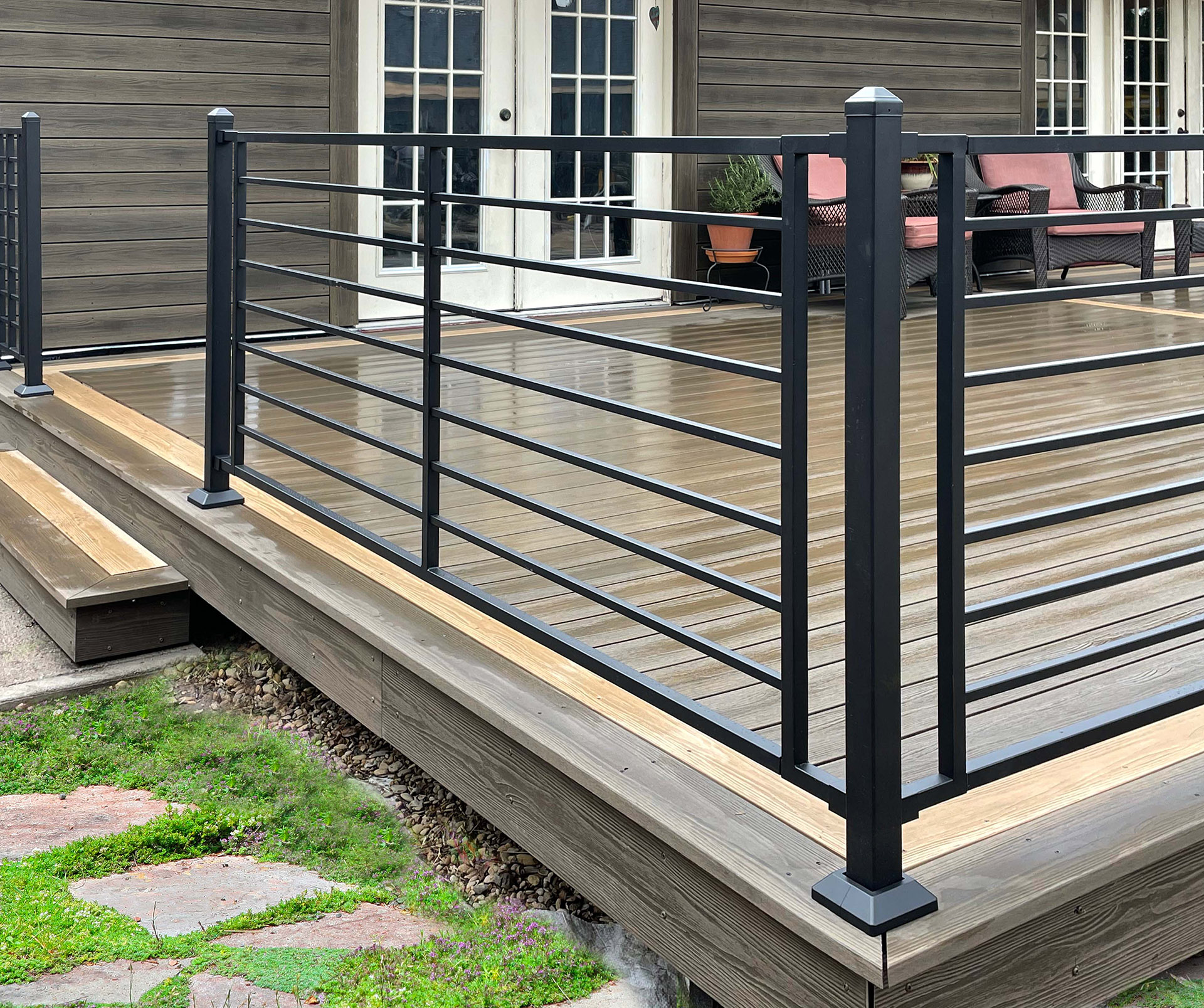 Black deck railing on back patio deck.